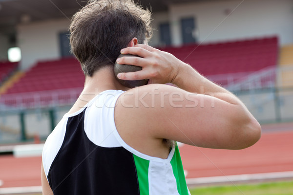 Concentrated male athlete preparing to throw weight in a stadium Stock photo © wavebreak_media