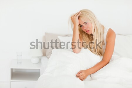 Cheerful woman squatting on a weighing machine in her bedroom Stock photo © wavebreak_media