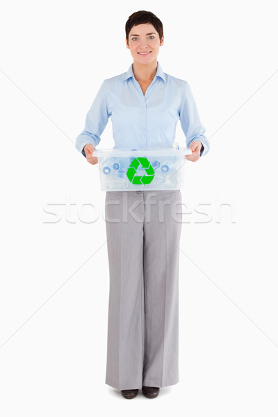 Businesswoman holding a recycling box against a white background Stock photo © wavebreak_media