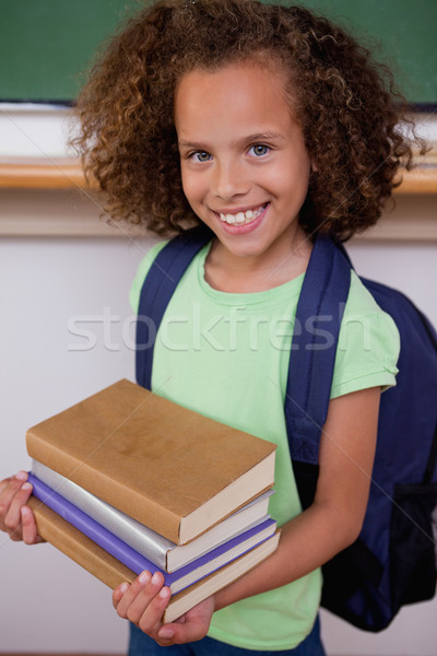 Portré iskolás lány tart könyvek osztályterem lány Stock fotó © wavebreak_media