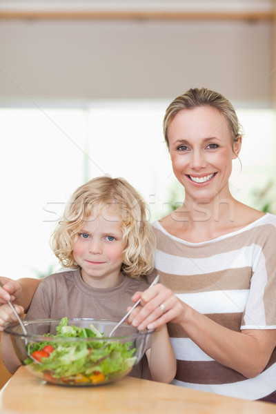 Smiling mother and son stirring salad together Stock photo © wavebreak_media