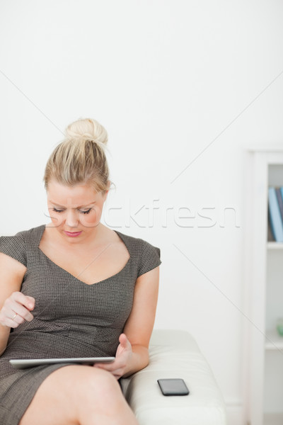 Woman searching something on a tablet tactile in a living room Stock photo © wavebreak_media