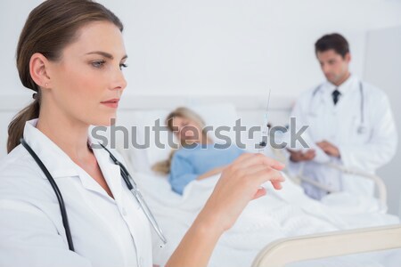 Stock photo: Smiling doctor auscultating a child in examination room