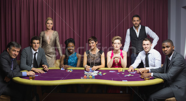 Well-dressed group at poker table in casino Stock photo © wavebreak_media