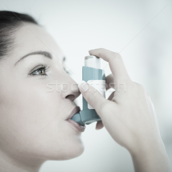 Woman using an asthma inhaler as prevention Stock photo © wavebreak_media