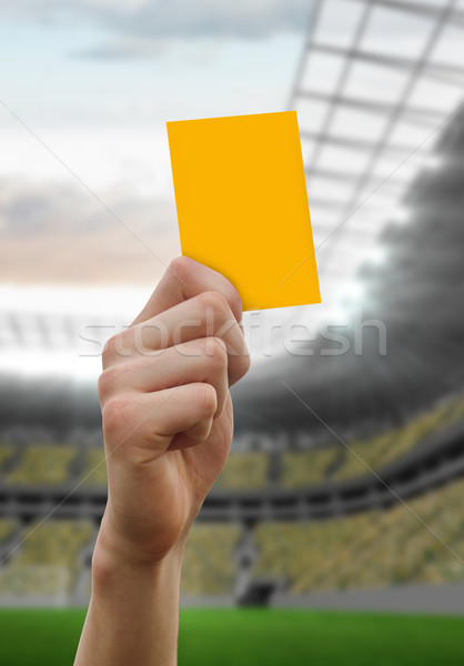 Composite image of hand holding up yellow card Stock photo © wavebreak_media