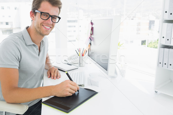 Casual male photo editor using graphics tablet Stock photo © wavebreak_media