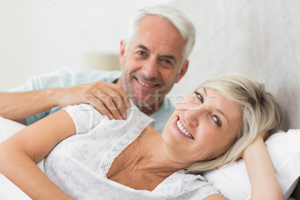Closeup of a smiling mature couple lying in bed Stock photo © wavebreak_media