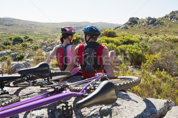 Fit cyclist couple sitting at the summit smiling at each other Stock photo © wavebreak_media