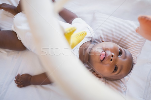 Adorable baby boy lying in his crib playing with mobile Stock photo © wavebreak_media