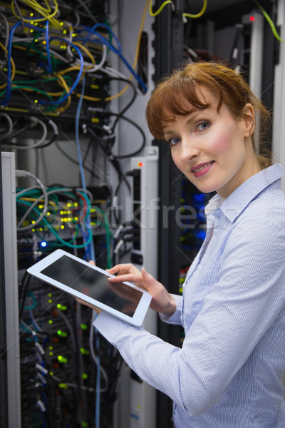 Smiling technician using tablet pc while analysing server Stock photo © wavebreak_media