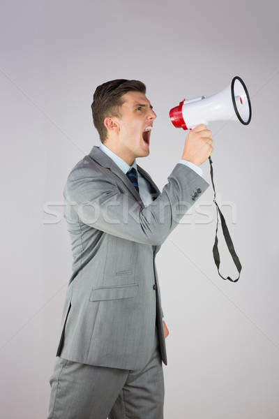 Supărat om de afaceri megafon gri costum Imagine de stoc © wavebreak_media