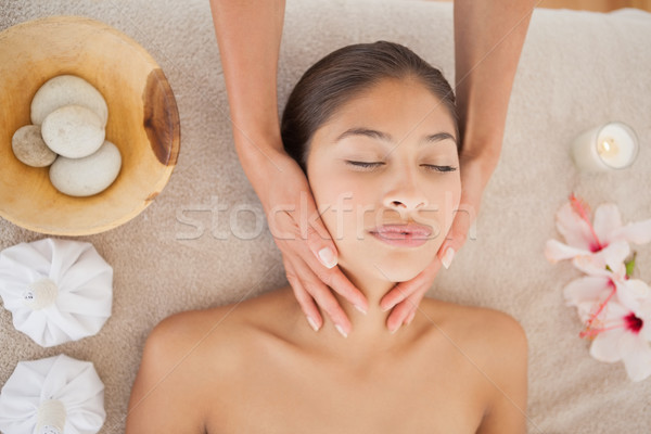 Beautiful brunette enjoying a head massage Stock photo © wavebreak_media