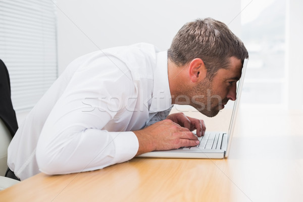 Confused businessman looking at his laptop Stock photo © wavebreak_media