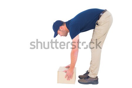 Side view of delivery man picking cardboard box Stock photo © wavebreak_media