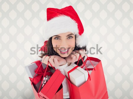 Composite image of smiling brunette holding shopping bags full o Stock photo © wavebreak_media
