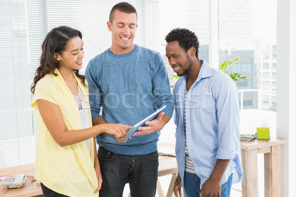 Portrait of smiling colleagues standing and using tablet compute Stock photo © wavebreak_media