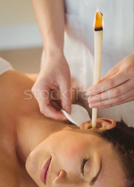 Young woman getting an ear candling treatment Stock photo © wavebreak_media