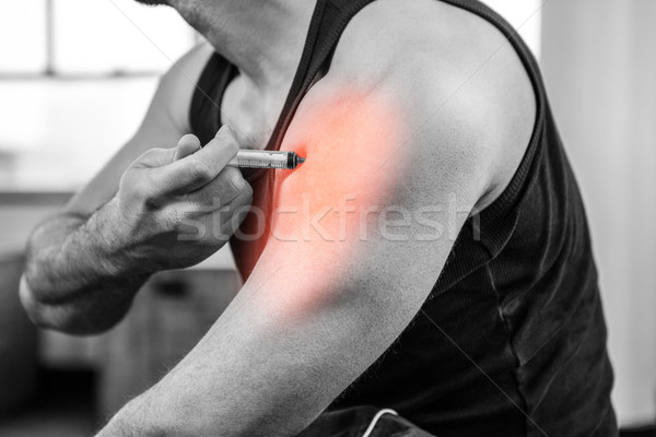 Highlighted arm of strong man injecting anabolic steroid at gym Stock photo © wavebreak_media