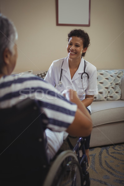 Female doctor interacting with senior woman on wheelchair Stock photo © wavebreak_media