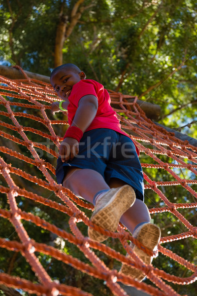 Menino escalada com treinamento bota Foto stock © wavebreak_media