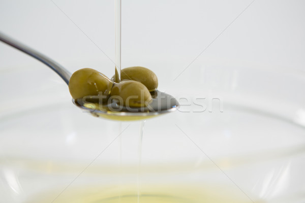 Green olive oil being poured in spoon Stock photo © wavebreak_media