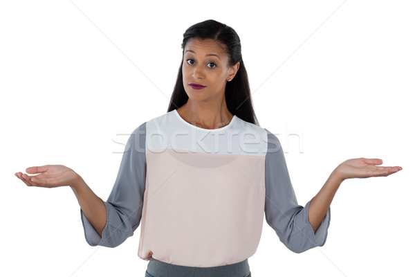 Frowning businesswoman shrugging her shoulders Stock photo © wavebreak_media