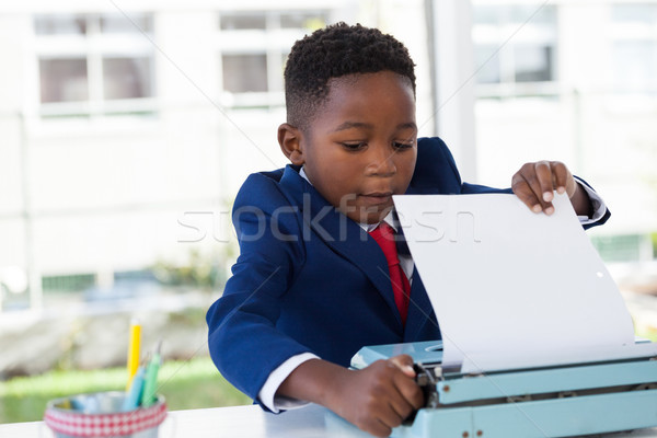 Businessman attaching paper in typewriter Stock photo © wavebreak_media
