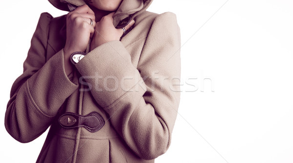 Attractive woman wearing a warm coat with hood raised Stock photo © wavebreak_media