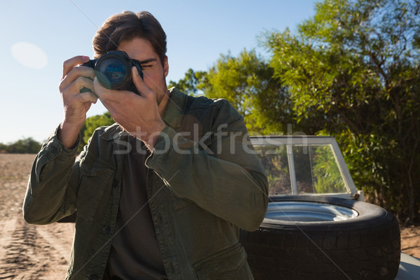 Young man photographing by vehicle Stock photo © wavebreak_media