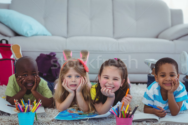 Smiling kids drawing pictures on paper Stock photo © wavebreak_media