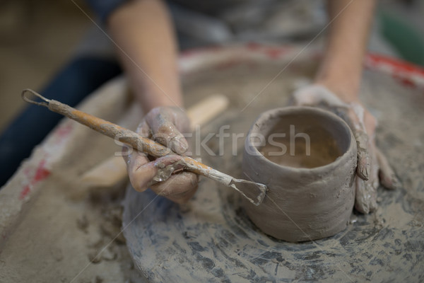 Female potter molding plate with hand tool Stock photo © wavebreak_media
