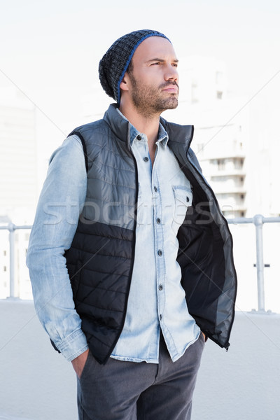 Confident young man wearing beanie hat and jacket Stock photo © wavebreak_media