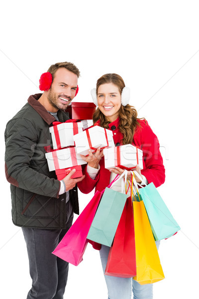 Happy young couple holding gifts and shopping bags Stock photo © wavebreak_media