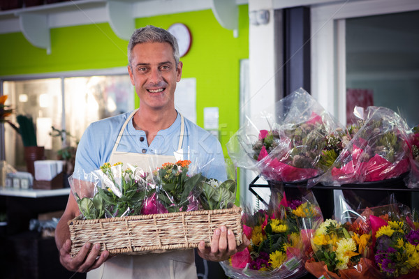 Male florist carrying plant pot in wicker basket Stock photo © wavebreak_media