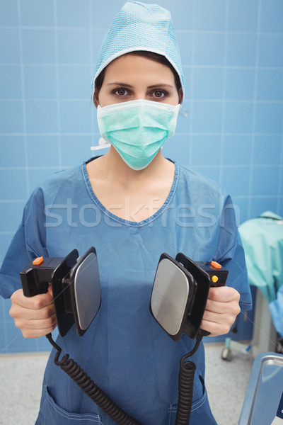 Portrait of female surgeon holding defibrillator Stock photo © wavebreak_media