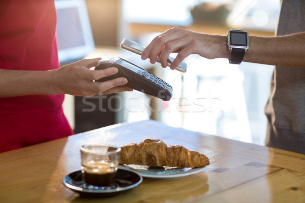 Man paying bill through smartphone using NFC technology Stock photo © wavebreak_media