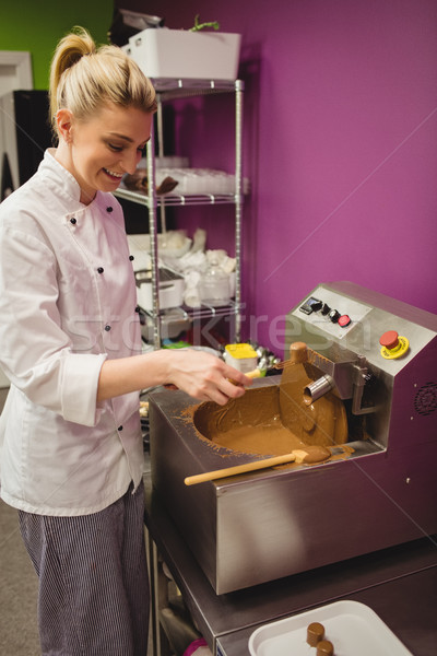 Worker dipping marshmallow in chocolate blending machine Stock photo © wavebreak_media