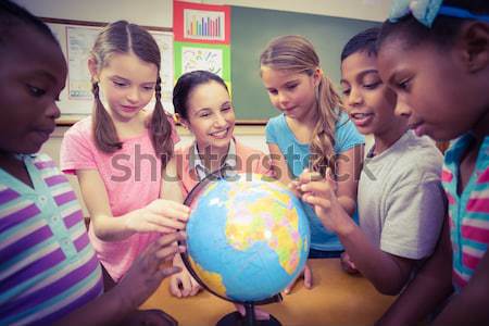 International business people looking at a terrestrial globe  Stock photo © wavebreak_media