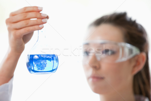 Close up of a scientist looking at flask with the camera focus on the object Stock photo © wavebreak_media