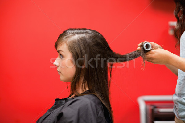 Young woman having her hair rolled with a curler Stock photo © wavebreak_media