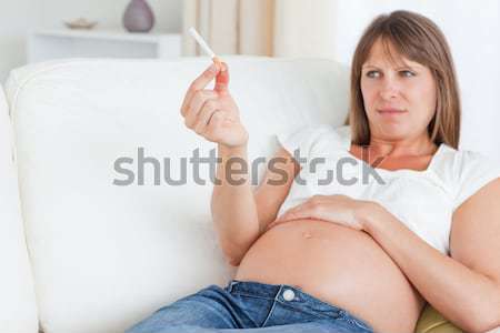 Young female crossing arms over her breast against a white background Stock photo © wavebreak_media