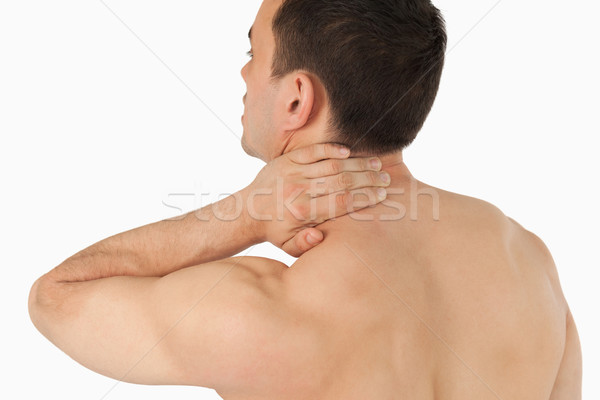 Young man experiencing neck pain against a white background Stock photo © wavebreak_media