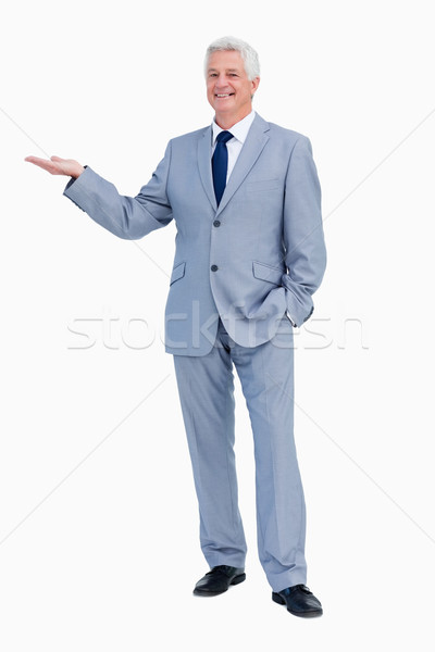 Portrait of a businessman presenting with hand against white background Stock photo © wavebreak_media