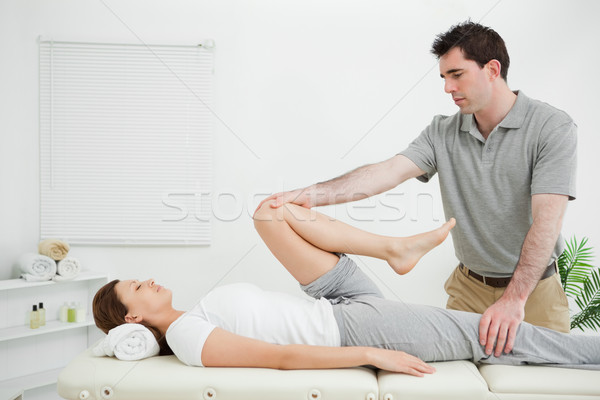 Woman lying on her back while being stretched in a room Stock photo © wavebreak_media