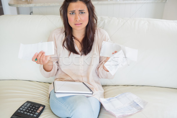 Woman getting stressed over bills on sofa Stock photo © wavebreak_media