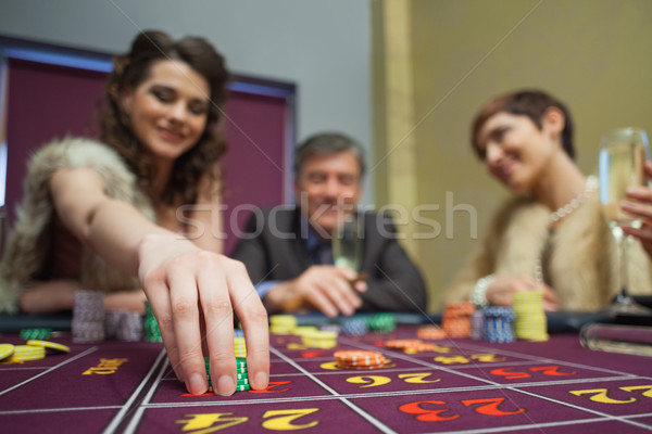 Woman is placing a bet in roulette in casino Stock photo © wavebreak_media