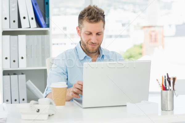 улыбаясь человека рабочих столе ноутбука Creative Сток-фото © wavebreak_media