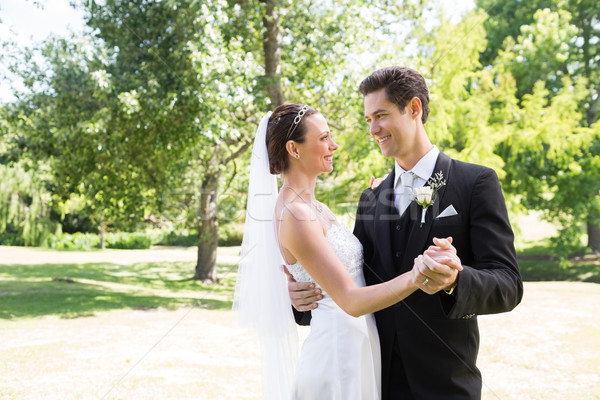 Loving bride and groom dancing in garden Stock photo © wavebreak_media