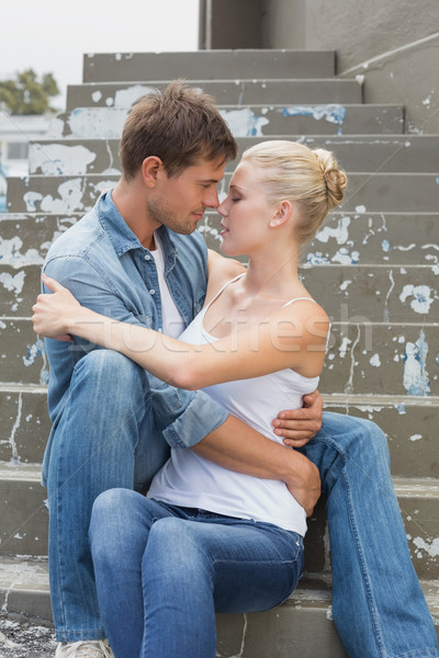 Hip young couple sitting on steps showing affection Stock photo © wavebreak_media